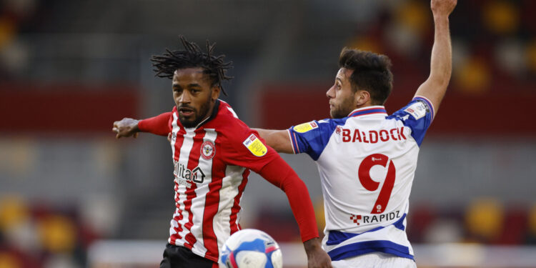 Soccer Football - Championship - Brentford v Reading - Brentford Community Stadium, London, Britain - December 19, 2020 Brentford's Tariqe Fosu in action with Reading’s Sam Baldock Action Images/John Sibley EDITORIAL USE ONLY. No use with unauthorized audio, video, data, fixture lists, club/league logos or 'live' services. Online in-match use limited to 75 images, no video emulation. No use in betting, games or single club /league/player publications. Please contact your account representative for further details.