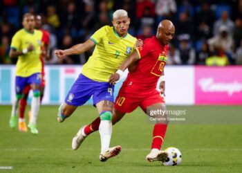 LE HAVRE, FRANCE - SEPTEMBER 23: Richarlison #9 of Brazil challenges Andre Ayew #10 of Ghana during the international friendly match between Brazil and Ghana at Stade Oceane on September 23, 2022 in Le Havre, France. (Photo by Catherine Steenkeste/Getty Images)