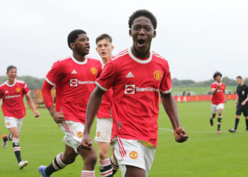 MANCHESTER, ENGLAND - SEPTEMBER 25: Kobbie Mainoo of Manchester United U18s celebrates Marc Jurado scoring their first goalduring the U18 Premier League match between Manchester United U18s and Stoke City U18s at Carrington Training Ground on September 25, 2021 in Manchester, England. (Photo by John Peters/Manchester United via Getty Images)