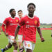 MANCHESTER, ENGLAND - SEPTEMBER 25: Kobbie Mainoo of Manchester United U18s celebrates Marc Jurado scoring their first goalduring the U18 Premier League match between Manchester United U18s and Stoke City U18s at Carrington Training Ground on September 25, 2021 in Manchester, England. (Photo by John Peters/Manchester United via Getty Images)