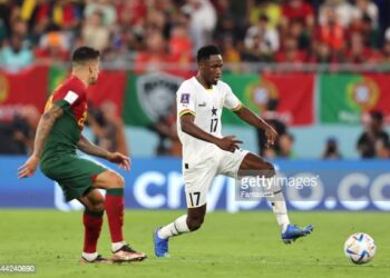 DOHA, QATAR - NOVEMBER 24: Baba Rahman of Ghana and Joao Cancelo of Portugal during the FIFA World Cup Qatar 2022 Group H match between Portugal and Ghana at Stadium 974 on November 24, 2022 in Doha, Qatar. (Photo by Youssef Loulidi/Fantasista/Getty Images)
