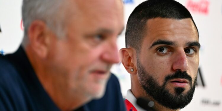 Australia's defender Aziz Behich (R) looks at coach Graham Arnold during a press conference. Photo: Chandan Khanna / AFP Source: AFP