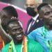 (From L) Senegal's forward Sadio Mane, Senegal's goalkeeper Edouard Mendy and Senegal's forward Bamba Dieng celebrate after winning the Africa Cup of Nations (CAN) 2021 final football match between Senegal and Egypt at Stade d'Olembe in Yaounde on February 6, 2022. (Photo by Kenzo TRIBOUILLARD / AFP) (Photo by KENZO TRIBOUILLARD/AFP via Getty Images)