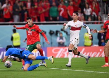 Morocco's goalkeeper #01 Yassine Bounou saves a shot by Portugal's forward #07 Cristiano Ronaldo during the Qatar 2022 World Cup quarter-final football match between Morocco and Portugal at the Al-Thumama Stadium in Doha on December 10, 2022. (Photo by Kirill KUDRYAVTSEV / AFP)