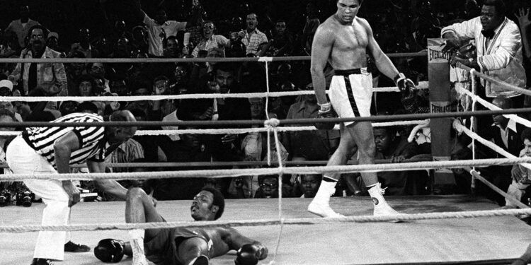 FILE -- Referee Zack Clayton counts out George Foreman as Muhammed Ali looks on in the 8th round of their title bout in Kinshasa, Zaire, in this Oct. 30, 1974 photo. (AP Photo/Jim Boudier, File)