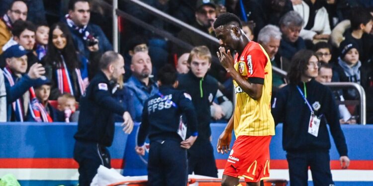 RC Lens midfielder Abdul Salis Samed leaves the pitch after being red carded following a harsh tackle on PSG star Achraf Hakimi