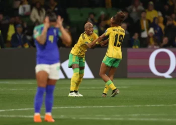 Jamaica's Deneisha Blackwood, centre, celebrates with her teammate Jamaica's Tiernny Wiltshire as the Reggae Girlz make it to the knockout round for the first time [Hamish Blair/AP Photo]