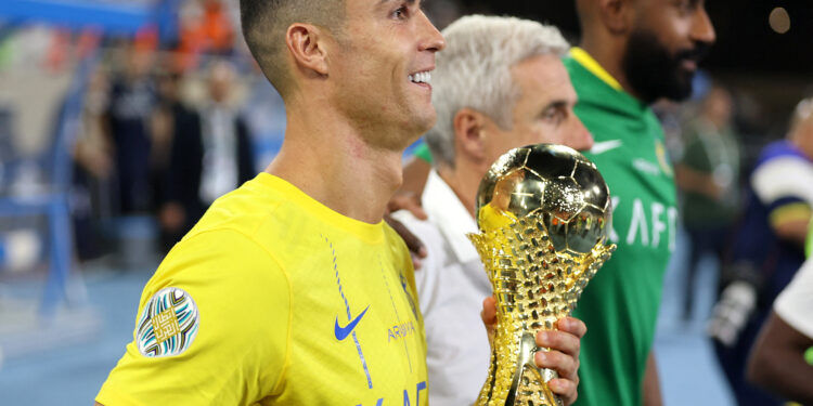Soccer Football - Arab Club Champions Cup - Final - Al Hilal v Al Nassr - King Fahd Stadium, Taif, Saudi Arabia - August 12, 2023 Al Nassr's Cristiano Ronaldo celebrates with the trophy after winning the Arab Club Champions Cup final  REUTERS/Stringer