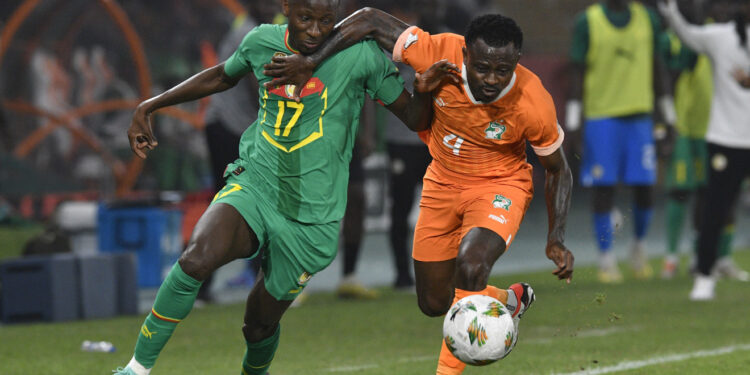 Jean Michael Seri of Cote dIvoire  challenges Pape Matar Sarr of Senegal during the 2023 Africa Cup of Nations  Last 16 match between Senegal and Ivory Coast at  Charles Konan Stadium in Yamoussoukro on the 29 January 2024 © Sydney Mahlangu/BackpagePix