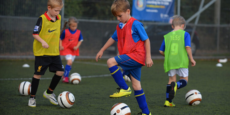 WHETSTONE, ENGLAND - OCTOBER 03:  Boys and girls taking part in the FA Skills training session at Holmes Park on October 3, 2014 in Whetstone, England.  (Photo by Tony Marshall - The FA/The FA via Getty Images)
