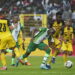 Nigeria's Victor Osimhen, centre is challenged by Ghana’s Daniel Amartey, right, during their 2022 Qatar World Cup qualifying playoff second leg at Moshood Abiola Stadium in Abuja, Nigeria, Tuesday, March. 29, 2022. Ghana became the first team from Africa to qualify for the World Cup in Qatar after a 1-1 draw with Nigeria in the second leg of their playoff on Tuesday to advance on away goals. (AP Photo/Sunday Alamba)