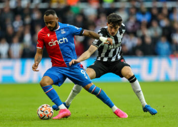 NEWCASTLE UPON TYNE, ENGLAND - OCTOBER 21: Crystal Palace's Jordan Ayew shields the ball from Newcastle United's Tino Livramento during the Premier League match between Newcastle United and Crystal Palace at St. James Park on October 21, 2023 in Newcastle upon Tyne, England. (Photo by Alex Dodd - CameraSport via Getty Images)