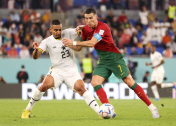 DOHA, QATAR - NOVEMBER 24: Cristiano Ronaldo of Portugal and Alexander Djiku of Ghana compete for the ball during the FIFA World Cup Qatar 2022 Group H match between Portugal and Ghana at Stadium 974 on November 24, 2022 in Doha, Qatar. (Photo by Sarah Stier - FIFA/FIFA via Getty Images)
