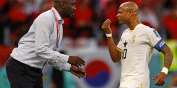 TOPSHOT - Ghana's coach Otto Addo (L) speaks with Ghana's midfielder #10 Andre Ayew during the Qatar 2022 World Cup Group H football match between South Korea and Ghana at the Education City Stadium in Al-Rayyan, west of Doha, on November 28, 2022. (Photo by Khaled DESOUKI / AFP) (Photo by KHALED DESOUKI/AFP via Getty Images)