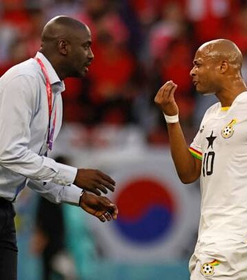TOPSHOT - Ghana's coach Otto Addo (L) speaks with Ghana's midfielder #10 Andre Ayew during the Qatar 2022 World Cup Group H football match between South Korea and Ghana at the Education City Stadium in Al-Rayyan, west of Doha, on November 28, 2022. (Photo by Khaled DESOUKI / AFP) (Photo by KHALED DESOUKI/AFP via Getty Images)