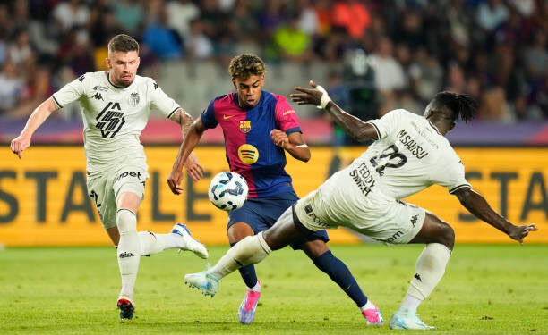 Lamine Yamal right wingerof Barcelona and Spain and Mohammed Salisu centre-back of Monaco and Ghana compete for the ball during the Joan Gmaper Trophy match between FC Barcelona and AS Monaco at Estadi Olimpic Lluis Companys on August 12, 2024 in Barcelona, Spain. (Photo by Jose Breton/Pics Action/NurPhoto via Getty Images)