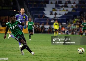 NASHVILLE, TN - AUGUST 24: Austin FC midfielder Osman Bukari (7) scores a goal from midfield in front of Nashville SC goalkeeper Joe Willis (1) during a match between Nashville SC and Austin FC, August 24, 2024 at GEODIS Park in Nashville, Tennessee (Photo by Matthew Maxey/Icon Sportswire via Getty Images)