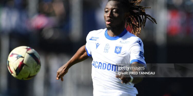 Auxerre's Ghanaian defender Gideon Mensah runs with the ball during the French L1 football match between FC Lorient and AJ Auxerre at Stade du Moustoir in Lorient, western France on February 26, 2023. (Photo by FRED TANNEAU / AFP) (Photo by FRED TANNEAU/AFP via Getty Images)