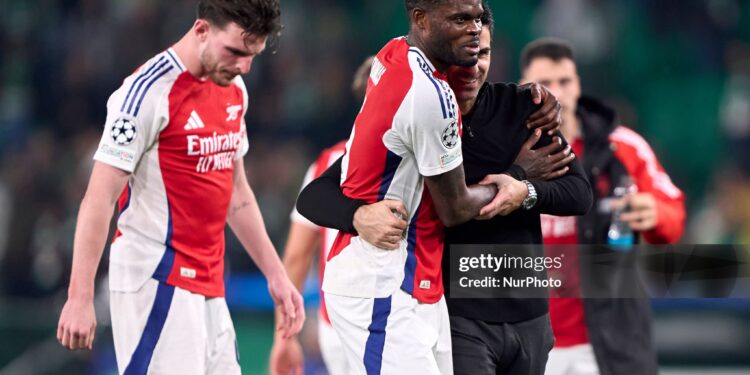 Mikel Arteta, Head Coach of Arsenal FC, celebrates victory with Thomas Partey of Arsenal FC after the UEFA Champions League match between Sporting CP and Arsenal FC at Jose Alvalade Stadium in Lisbon, Portugal, on November 26, 2024. (Photo by Jose Manuel Alvarez Rey/JAR Sport Images/NurPhoto via Getty Images)