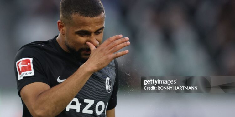 Freiburg's Ghanaian midfielder Daniel-Kofi Kyereh clears his nose during the German first division Bundesliga football match VfL Wolfsburg v SC Freiburg in Wolfsburg, northern Germany, on January 21, 2023. - - DFL REGULATIONS PROHIBIT ANY USE OF PHOTOGRAPHS AS IMAGE SEQUENCES AND/OR QUASI-VIDEO (Photo by Ronny HARTMANN / AFP) / DFL REGULATIONS PROHIBIT ANY USE OF PHOTOGRAPHS AS IMAGE SEQUENCES AND/OR QUASI-VIDEO (Photo by RONNY HARTMANN/AFP via Getty Images)