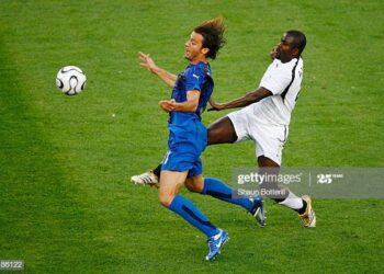 HANOVER, GERMANY - JUNE 12: Samuel Kuffour of Ghana thwarts the progress of Alberto Gilardino of Italy during the FIFA World Cup Germany 2006 Group E match between Italy and Ghana played at the Stadium Hanover on June 12, 2006 in Hanover, Germany. (Photo by Shaun Botterill/Getty Images)