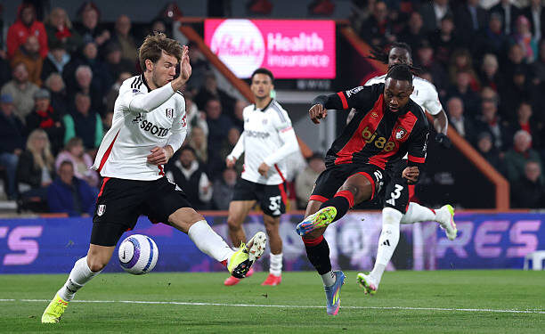 BOURNEMOUTH, ENGLAND - APRIL 14: Antoine Semenyo of AFC Bournemouth scores his team's first goal whilst under pressure from Joachim Andersen of Fulham during the Premier League match between AFC Bournemouth and Fulham FC at Vitality Stadium on April 14, 2025 in Bournemouth, England. (Photo by Michael Steele/Getty Images)