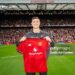 MANCHESTER, ENGLAND - AUGUST 9:   New Manchester United signing Benjamin Sesko poses with a team shirt prior to the pre-season friendly match between Manchester United and ACF Fiorentina at Old Trafford on August 9, 2025 in Manchester, England. (Photo by Ash Donelon/Manchester United via Getty Images)
