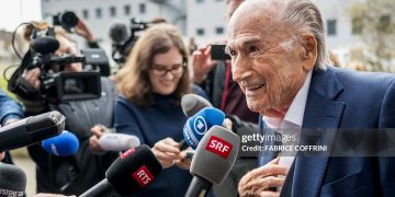 TOPSHOT - Former FIFA president Sepp Blatter (R) addresses media as he leaves the courthouse after the verdict of an appeal by Swiss Attorney General's office against former UEFA and FIFA presidents over a suspected fraudulent payment, in Muttenz near Basel, on March 25, 2025. Former FIFA president Sepp Blatter and ex-UEFA chief Michel Platini were acquitted again  on March 25, 2025 on appeal by a Swiss court in a long-running corruption case. (Photo by Fabrice COFFRINI / AFP) (Photo by FABRICE COFFRINI/AFP via Getty Images)