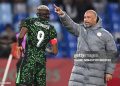 Nigeria's head coach Eric Chelle speaks to Nigeria's forward #09 Victor Osimhen during the Africa Cup of Nations (CAN) quarter-final football match between Algeria and Nigeria at the Grand stadium in Marrakesh on January 10, 2026. (Photo by SEBASTIEN BOZON / AFP via Getty Images)