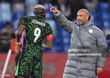 Nigeria's head coach Eric Chelle speaks to Nigeria's forward #09 Victor Osimhen during the Africa Cup of Nations (CAN) quarter-final football match between Algeria and Nigeria at the Grand stadium in Marrakesh on January 10, 2026. (Photo by SEBASTIEN BOZON / AFP via Getty Images)