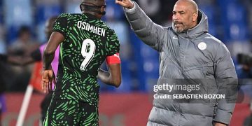 Nigeria's head coach Eric Chelle speaks to Nigeria's forward #09 Victor Osimhen during the Africa Cup of Nations (CAN) quarter-final football match between Algeria and Nigeria at the Grand stadium in Marrakesh on January 10, 2026. (Photo by SEBASTIEN BOZON / AFP via Getty Images)