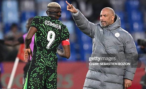 Nigeria's head coach Eric Chelle speaks to Nigeria's forward #09 Victor Osimhen during the Africa Cup of Nations (CAN) quarter-final football match between Algeria and Nigeria at the Grand stadium in Marrakesh on January 10, 2026. (Photo by SEBASTIEN BOZON / AFP via Getty Images)