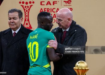 Senegal's forward #10 Sadio Mane speaks with FIFA President Gianni Infantino as Morocco's Prince Moulay Rachid looks on during presentation at the end of the Africa Cup of Nations (CAN) final football match between Senegal and Morocco at the Prince Moulay Abdellah Stadium in Rabat on January 18, 2026. (Photo by FRANCK FIFE / AFP via Getty Images)