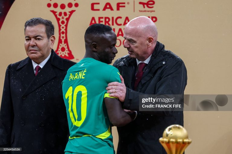 Senegal's forward #10 Sadio Mane speaks with FIFA President Gianni Infantino as Morocco's Prince Moulay Rachid looks on during presentation at the end of the Africa Cup of Nations (CAN) final football match between Senegal and Morocco at the Prince Moulay Abdellah Stadium in Rabat on January 18, 2026. (Photo by FRANCK FIFE / AFP via Getty Images)