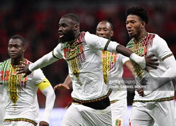 TOPSHOT - Mali's forward #17 Lassine Sinayoko (C) celebrates scoring the team's first goal from a penalty during the Africa Cup of Nations (CAN) Group A football match between Morocco and Mali at Prince Moulay Abdellah Stadium in Rabat on December 26, 2025. (Photo by Gabriel BOUYS / AFP via Getty Images)