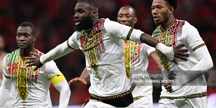 TOPSHOT - Mali's forward #17 Lassine Sinayoko (C) celebrates scoring the team's first goal from a penalty during the Africa Cup of Nations (CAN) Group A football match between Morocco and Mali at Prince Moulay Abdellah Stadium in Rabat on December 26, 2025. (Photo by Gabriel BOUYS / AFP via Getty Images)