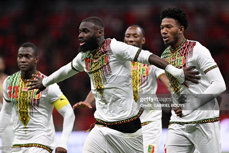 TOPSHOT - Mali's forward #17 Lassine Sinayoko (C) celebrates scoring the team's first goal from a penalty during the Africa Cup of Nations (CAN) Group A football match between Morocco and Mali at Prince Moulay Abdellah Stadium in Rabat on December 26, 2025. (Photo by Gabriel BOUYS / AFP via Getty Images)