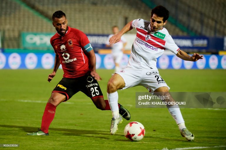 Egypts al-Ahly player Hossam Ashour (L) fights for the ball against Zamalek's Ahmed Madbouly during the the Egyptian Premier League football match between Al-Ahly and Zamalek at the Cairo Stadium in the Egyptian capital on January 8, 2018. / AFP PHOTO / KHALED DESOUKI        (Photo credit should read KHALED DESOUKI/AFP via Getty Images)