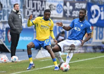 14 February 2026, Lower Saxony, Brunswick: Soccer: Bundesliga 2, Eintracht Braunschweig - Darmstadt 98, Matchday 22, Eintracht Stadium. Aaron Opoku (Eintracht Braunschweig) plays against Patric Pfeiffer (SV Darmstadt 98). Photo: Swen Pförtner/dpa - IMPORTANT NOTE: In accordance with the regulations of the DFL German Football League and the DFB German Football Association, it is prohibited to utilize or have utilized photographs taken in the stadium and/or of the match in the form of sequential images and/or video-like photo series. (Photo by Swen Pförtner/picture alliance via Getty Images)