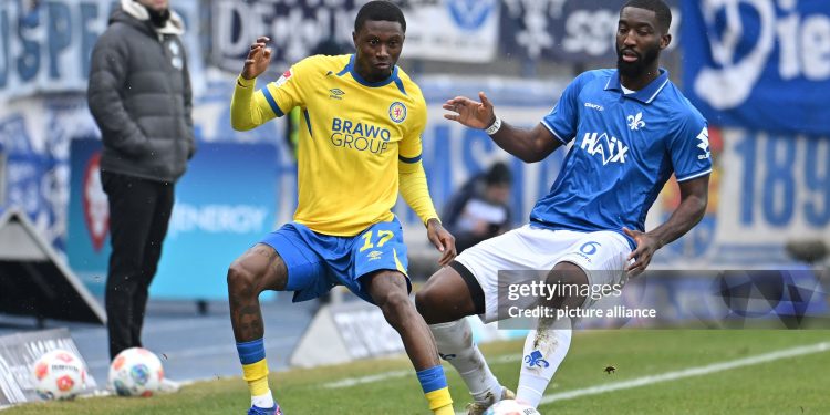 14 February 2026, Lower Saxony, Brunswick: Soccer: Bundesliga 2, Eintracht Braunschweig - Darmstadt 98, Matchday 22, Eintracht Stadium. Aaron Opoku (Eintracht Braunschweig) plays against Patric Pfeiffer (SV Darmstadt 98). Photo: Swen Pförtner/dpa - IMPORTANT NOTE: In accordance with the regulations of the DFL German Football League and the DFB German Football Association, it is prohibited to utilize or have utilized photographs taken in the stadium and/or of the match in the form of sequential images and/or video-like photo series. (Photo by Swen Pförtner/picture alliance via Getty Images)