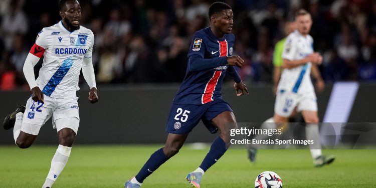 PARIS, FRANCE - MAY 17: Nuno Mendes of Paris Saint Germain (R) is chased by Elisha Owusu of Auxerre (L) during the France Ligue 1 match between Paris Saint-Germain FC and AJ Auxerre at Parc des Princes on May 17, 2025 in Paris, France. (Photo by Antonio Borga/Eurasia Sport Images/Getty Images)