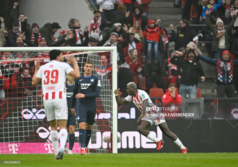 FC Cologne's German forward #09 Ragnar Ache (R) celebrates his 1-0 during the German first division Bundesliga football match 1 FC Cologne v TSG 1899 Hoffenheim in Cologne, western Germany, on February 21, 2026. (Photo by INA FASSBENDER / AFP via Getty Images) / DFL REGULATIONS PROHIBIT ANY USE OF PHOTOGRAPHS AS IMAGE SEQUENCES AND/OR QUASI-VIDEO
