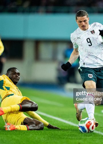 Ghana's midfielder #04 Jonas Adjetey (C) and Austria's forward #09 Marcel Sabitzer (R) vie for the ball during the friendly football match Austria vs Ghana in Vienna, Austria, on March 27, 2026. (Photo by GEORG HOCHMUTH / APA / AFP via Getty Images) / Austria OUT