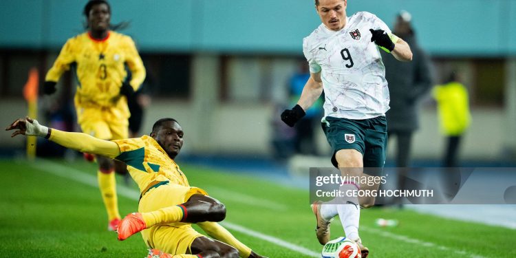 Ghana's midfielder #04 Jonas Adjetey (C) and Austria's forward #09 Marcel Sabitzer (R) vie for the ball during the friendly football match Austria vs Ghana in Vienna, Austria, on March 27, 2026. (Photo by GEORG HOCHMUTH / APA / AFP via Getty Images) / Austria OUT