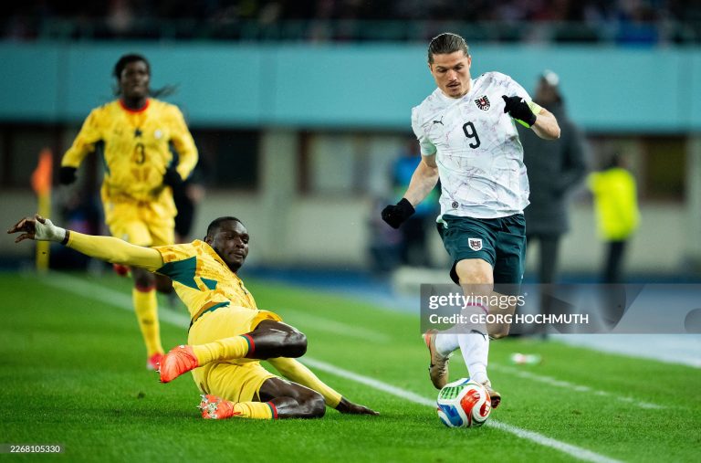 Ghana's midfielder #04 Jonas Adjetey (C) and Austria's forward #09 Marcel Sabitzer (R) vie for the ball during the friendly football match Austria vs Ghana in Vienna, Austria, on March 27, 2026. (Photo by GEORG HOCHMUTH / APA / AFP via Getty Images) / Austria OUT