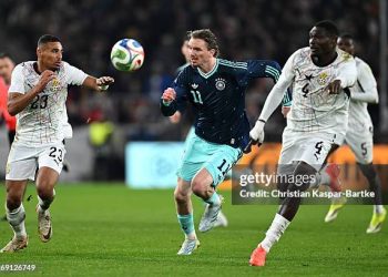 LUDWIGSBURG, GERMANY - MARCH 30: Nick Woltemade of Germany battles for the ball with Alexander Djiku and Jonas Adjetey of Ghana during the international friendly match between Germany and Ghana at MHP Arena on March 30, 2026 in Ludwigsburg, Germany. (Photo by Christian Kaspar-Bartke/Getty Images)