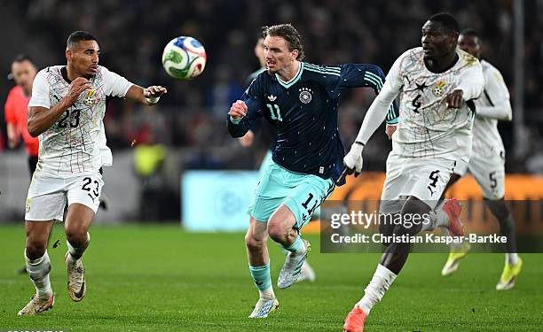 LUDWIGSBURG, GERMANY - MARCH 30: Nick Woltemade of Germany battles for the ball with Alexander Djiku and Jonas Adjetey of Ghana during the international friendly match between Germany and Ghana at MHP Arena on March 30, 2026 in Ludwigsburg, Germany. (Photo by Christian Kaspar-Bartke/Getty Images)