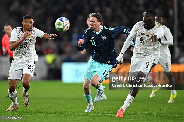 LUDWIGSBURG, GERMANY - MARCH 30: Nick Woltemade of Germany battles for the ball with Alexander Djiku and Jonas Adjetey of Ghana during the international friendly match between Germany and Ghana at MHP Arena on March 30, 2026 in Ludwigsburg, Germany. (Photo by Christian Kaspar-Bartke/Getty Images)