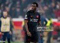 LEVERKUSEN, GERMANY - MARCH 11: Ernest Poku of Bayer 04 Leverkusen disappointed after the match  during the UEFA Champions League  match between Bayer Leverkusen v Arsenal at the BayArena on March 11, 2026 in Leverkusen Germany (Photo by Gerrit van Keulen/Soccrates/Getty Images)
