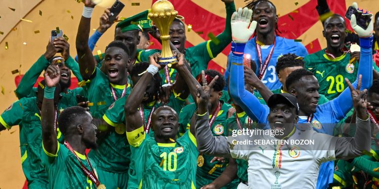 TOPSHOT - Senegal's forward #10 Sadio Mane holds the trophy after the Africa Cup of Nations (CAN) final football match between Senegal and Morocco at the Prince Moulay Abdellah Stadium in Rabat on January 18, 2026. (Photo by SEBASTIEN BOZON / AFP via Getty Images)